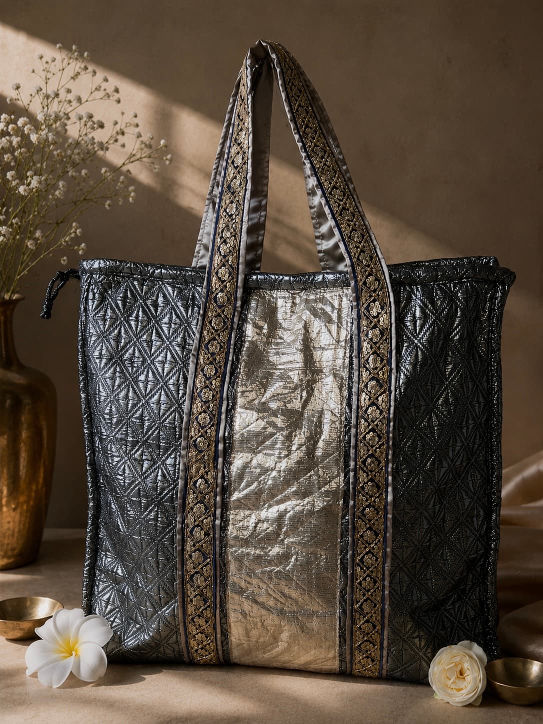 A handcrafted black and silver Kumud tote with embroidered handles